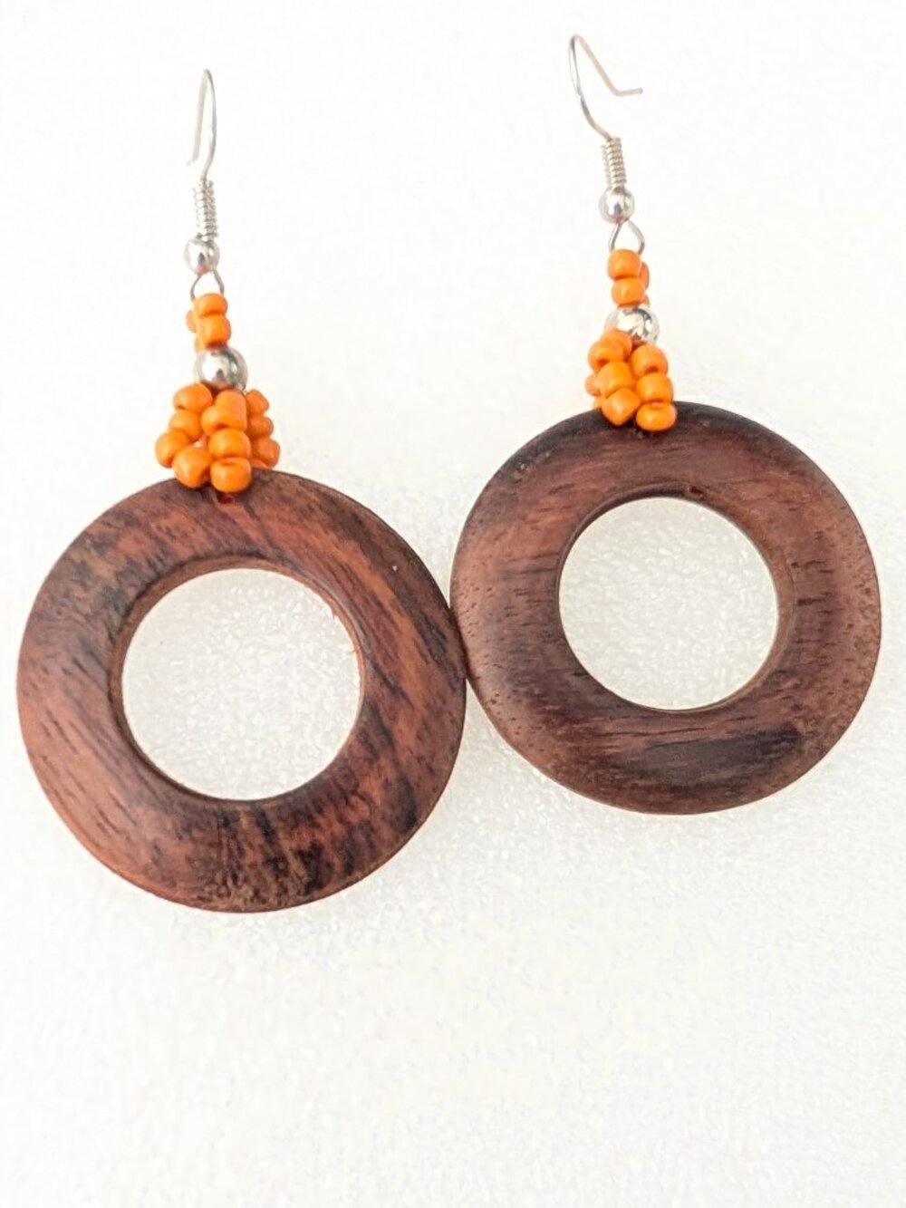 Wooden circle drop earrings with orange accent beads